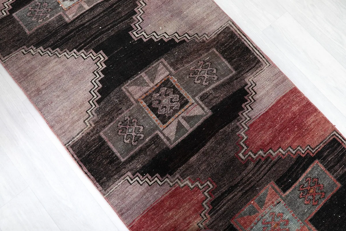 Overhead angled view of the runner, focusing on the repeating diamond and stepped patterns.