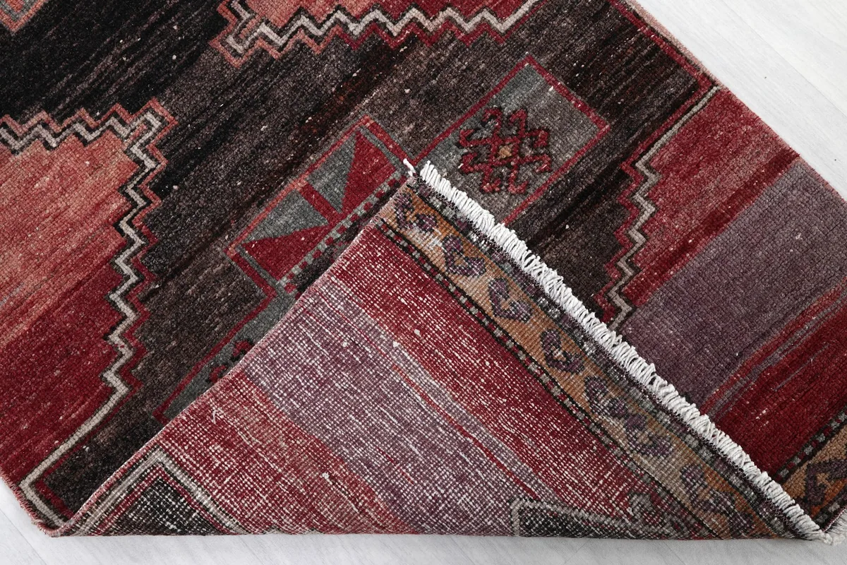 View of the back of the rug, showing the hand-knotted construction and cotton foundation.