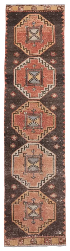 Full top view of the 2'7" x 9'11" vintage Anatolian runner rug with brown field and rust geometric medallions