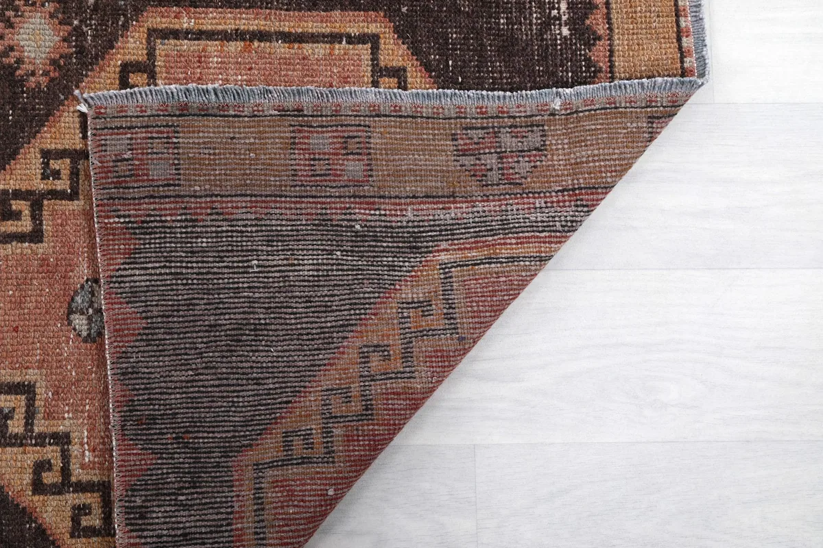 Another view of the rug's back, showing the construction and natural fibers