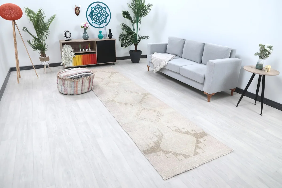 Angled view of the runner rug in a room setting, highlighting its muted colors and design