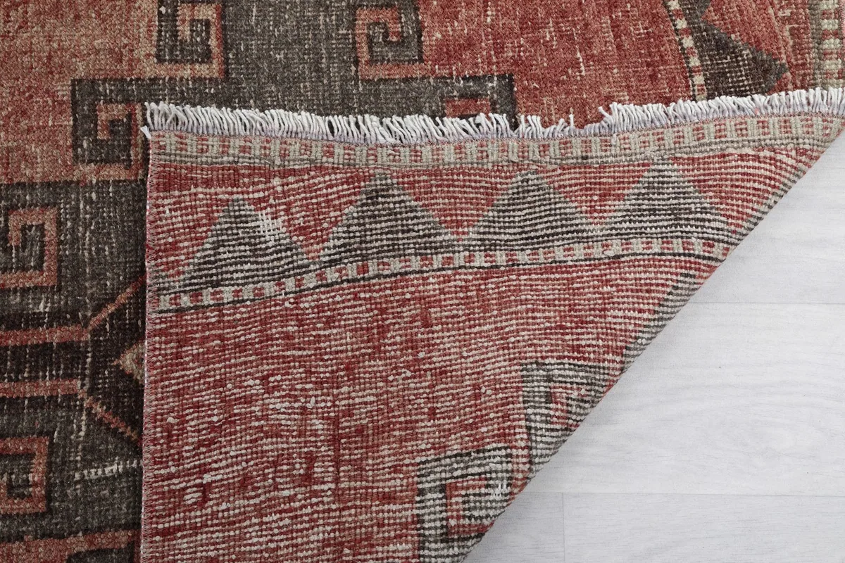 Underside view of the runner rug, showing the consistent knotting and cotton foundation structure.