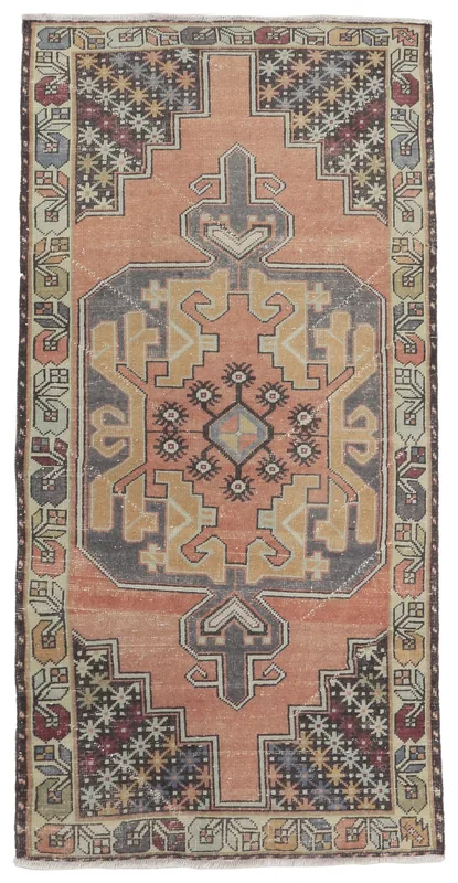 Full overhead view of the rust vintage Anatolian runner with geometric medallion on a white background