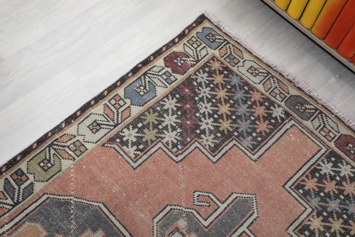 Close-up of the upper right corner of the rug, detailing the border and field patterns, including stars and floral elements