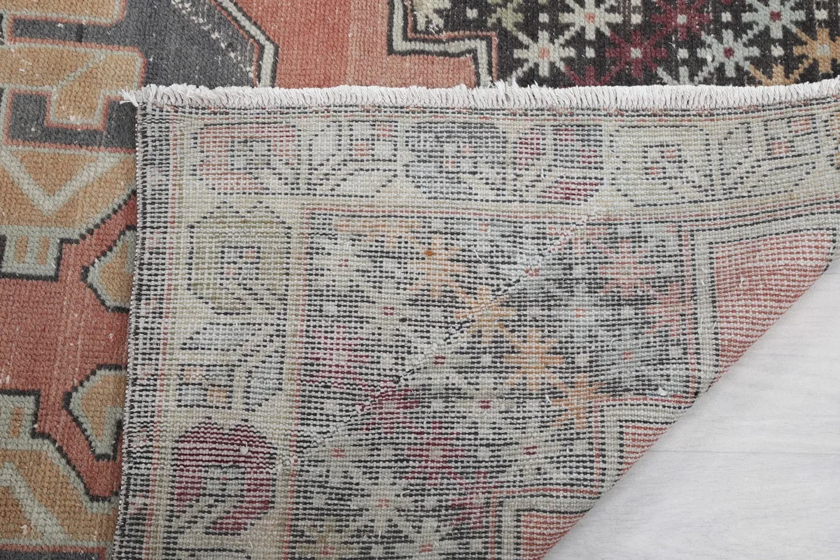Close-up view of the rug's low pile and the texture of the hand-knotted wool
