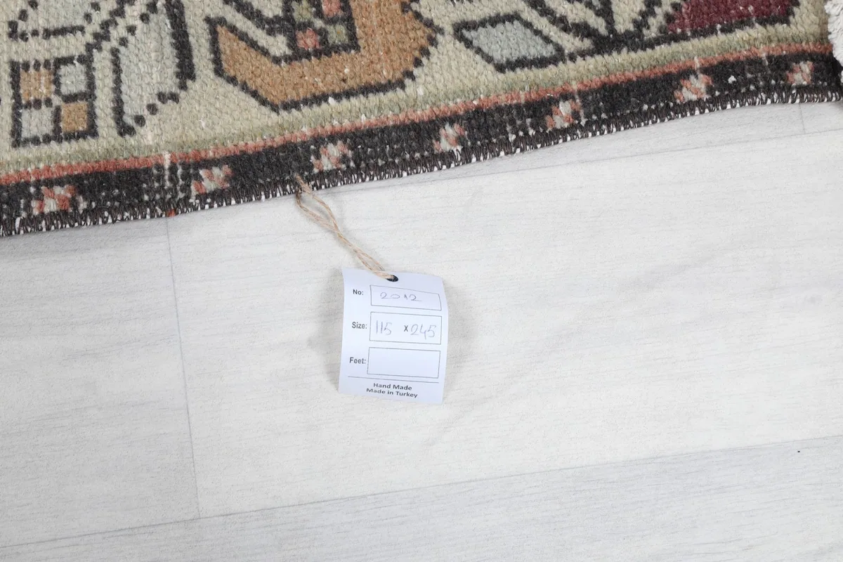 Tag attached to the rug, displaying item information and origin details