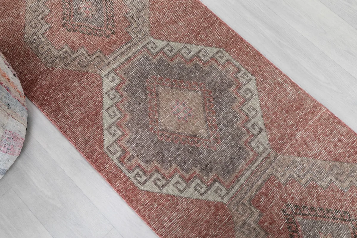 Angled view of the runner rug showing the distressed texture and color variation