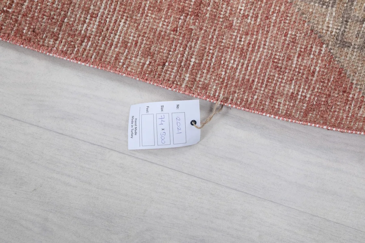 Close-up of the rug's edge with a tag showing size and origin information