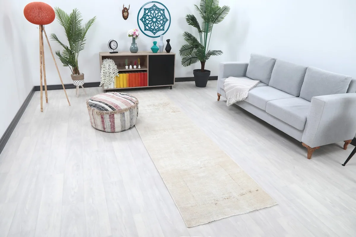 Runner rug extending through a contemporary living space, viewed from an angle