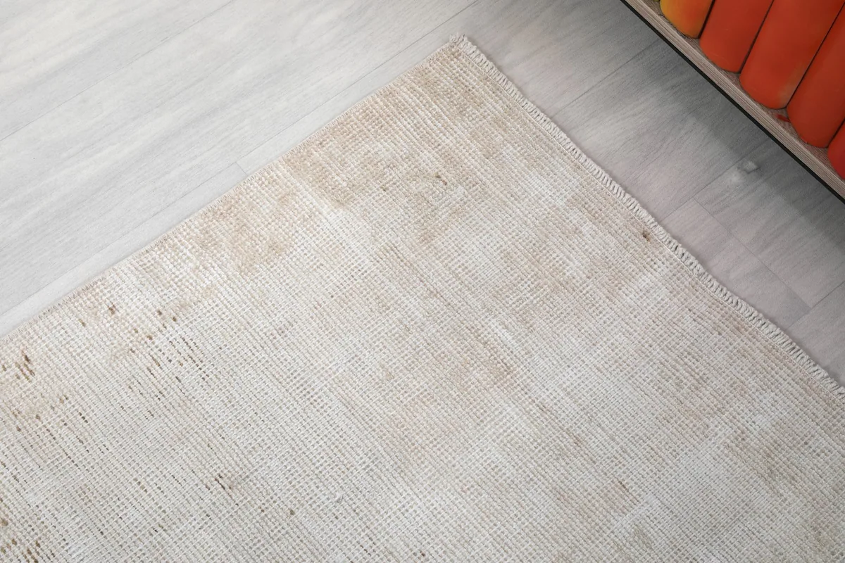 Corner detail of the rug, showing the edges and subtle color shifts