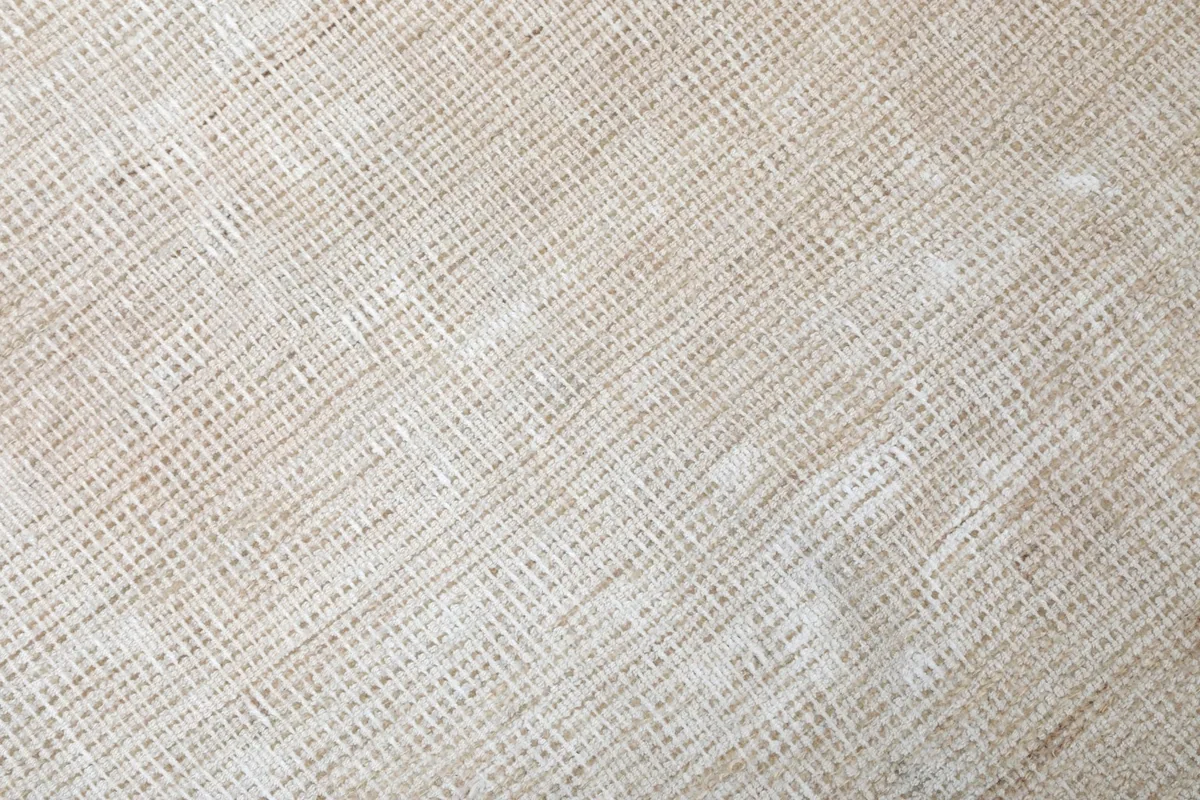 Close-up of the rug's low wool pile and cotton foundation texture