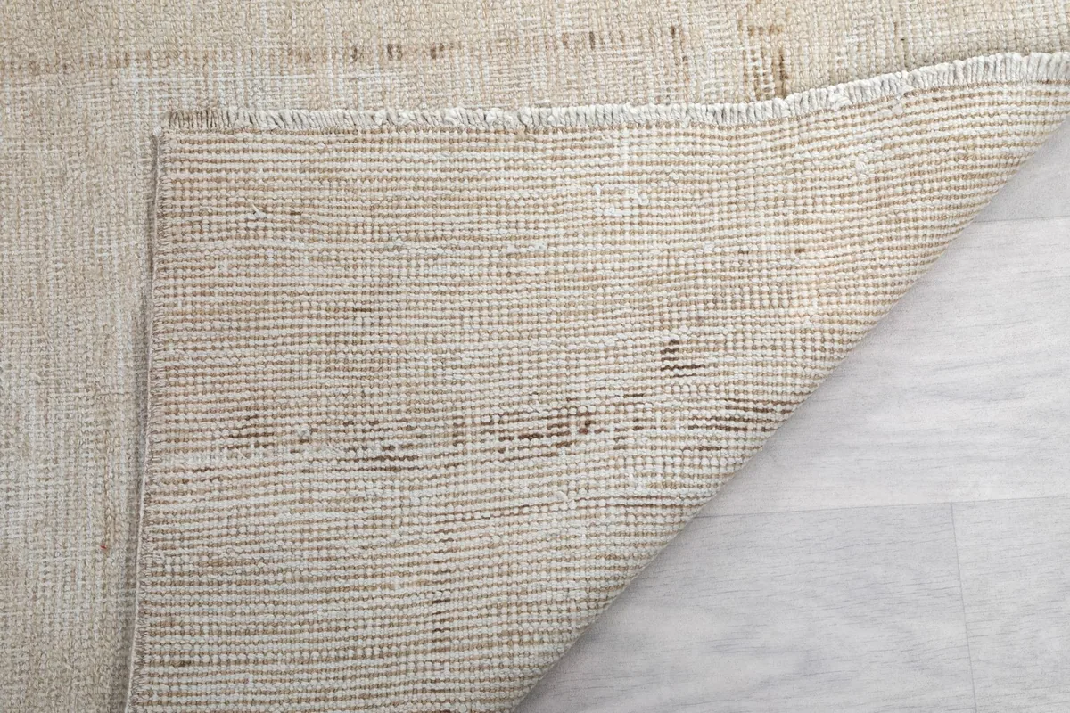 Another view of the rug's reverse side, showing the intricate knotting and foundation