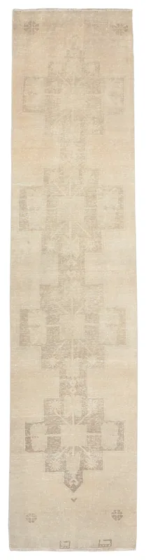 Full top view of the 2'9" x 12'3" beige geometric tribal runner rug on a white background.