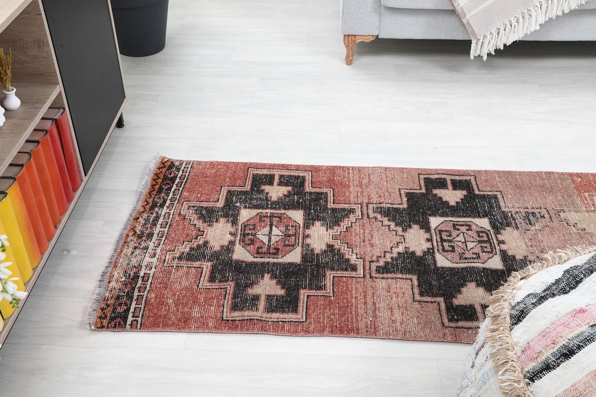 View of the runner rug from above, showcasing its length and pattern in a room setting.
