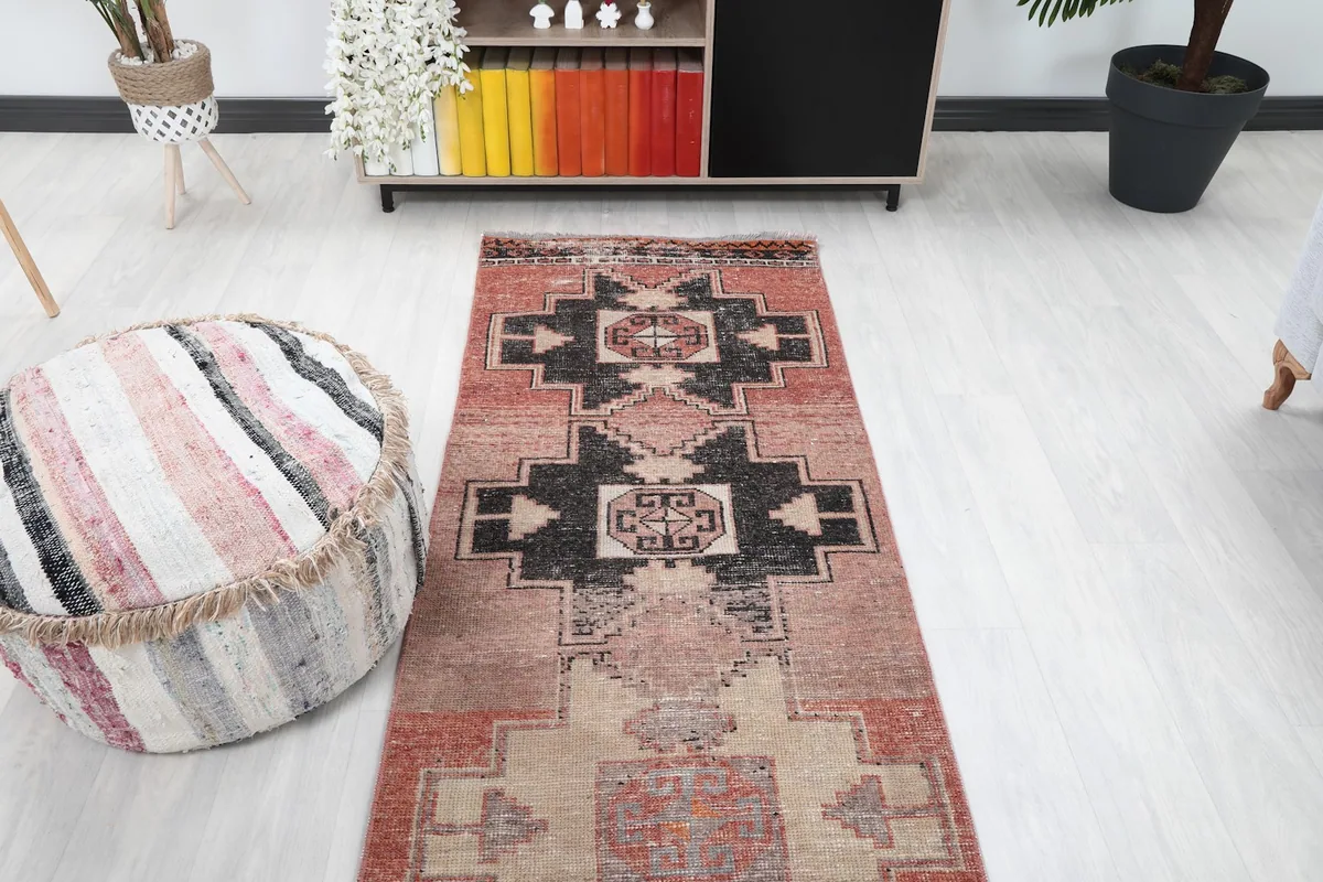 Overhead view of the runner rug's upper section, focusing on the prominent black and beige geometric designs.