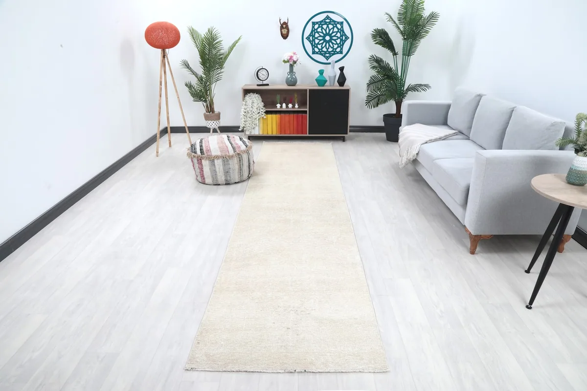 Ivory vintage runner rug displayed in a modern living room setting with light flooring