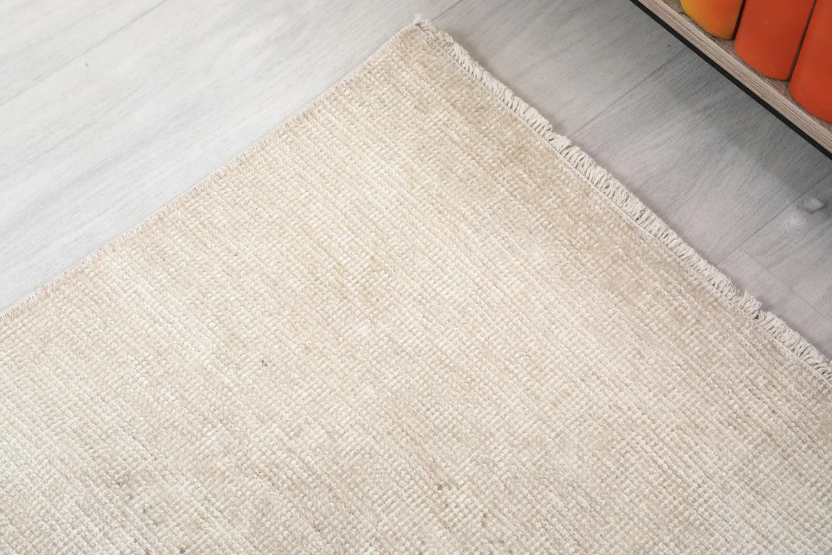 Corner detail of the rug, showing the edge finish and subtle color shifts