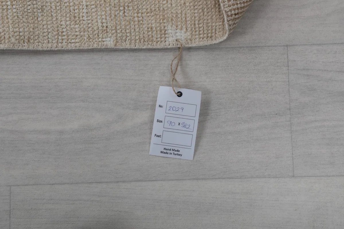 Close-up of the product tag attached to the rug, displaying size and origin