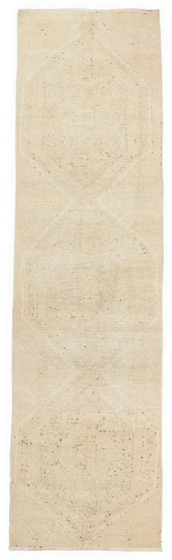 Overhead view of the 2'10" x 10'7" ivory geometric runner rug on a white background