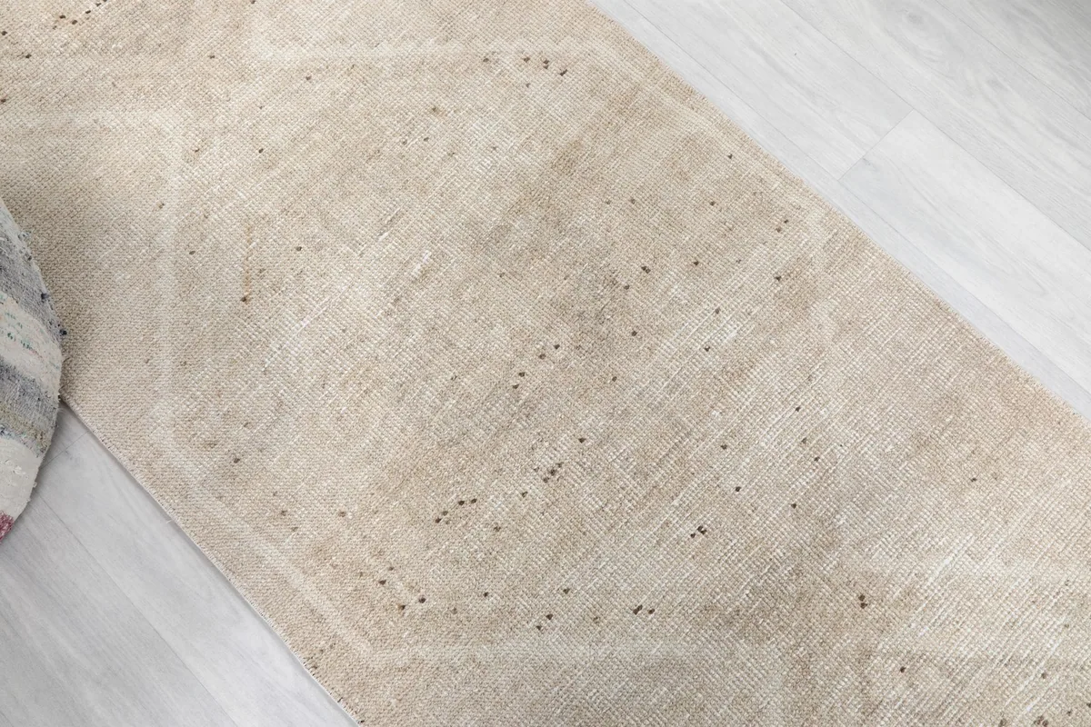 Angled view highlighting the vintage patina and subtle patterns of the runner
