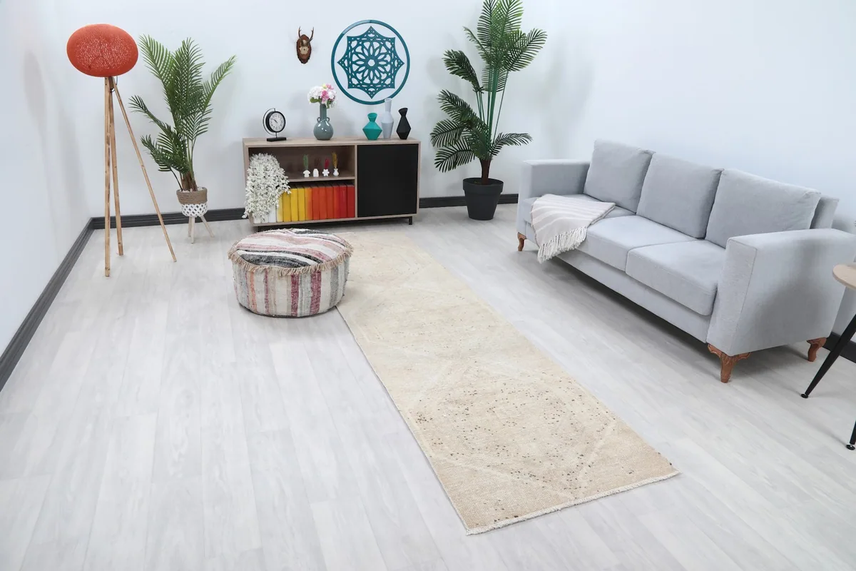 Full room view of the ivory runner rug extending from a sofa towards the foreground