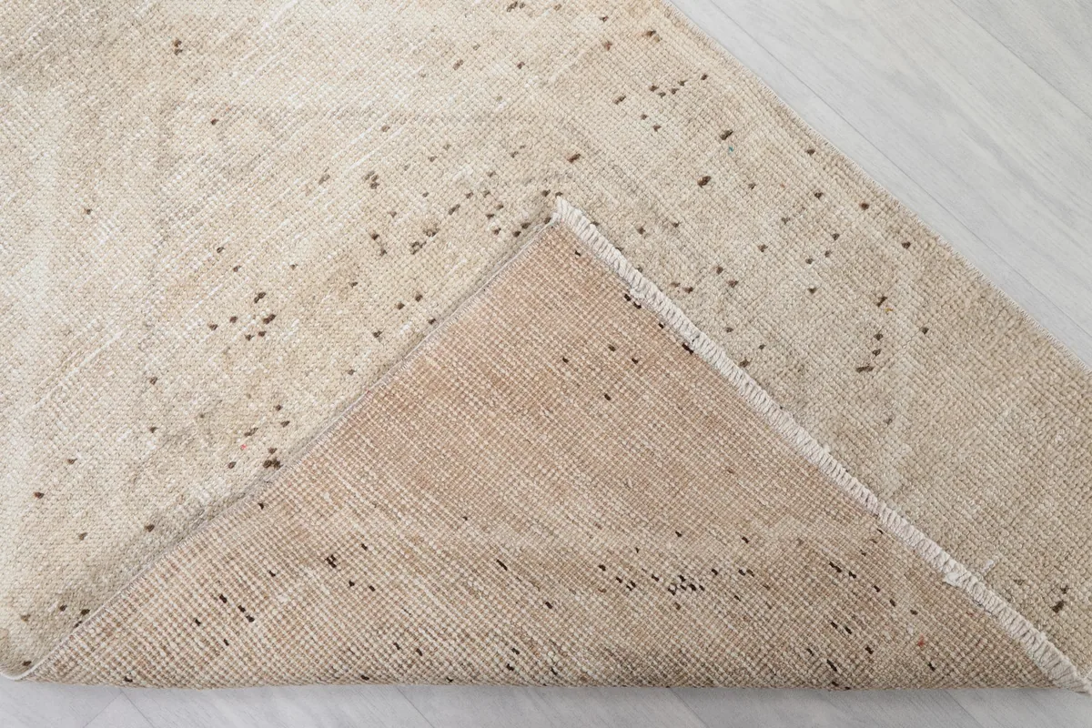 Underside view of the rug, revealing the cotton foundation and hand-knotted construction