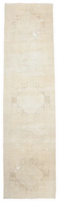 Full top view of the beige geometric Anatolian runner rug on a white background