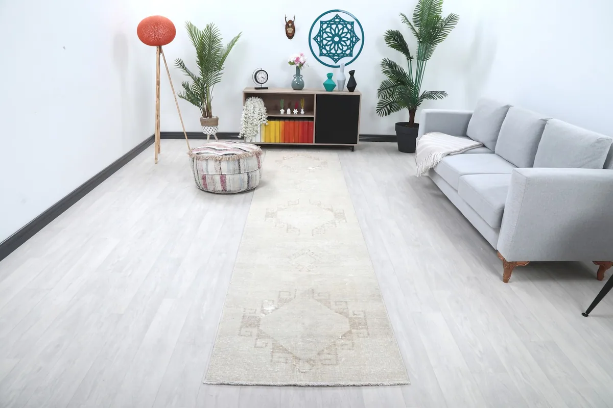 Runner rug in a modern living room setting with a couch and minimalist decor
