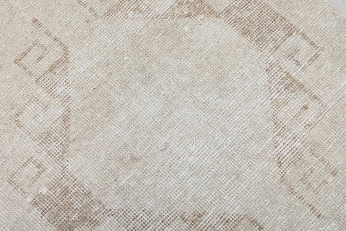 Close-up of a central geometric medallion with visible wear and character