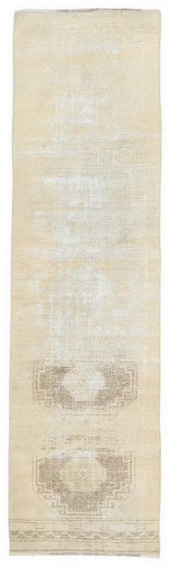 Full top view of the 2x8 cream and brown vintage Anatolian runner rug on a white background
