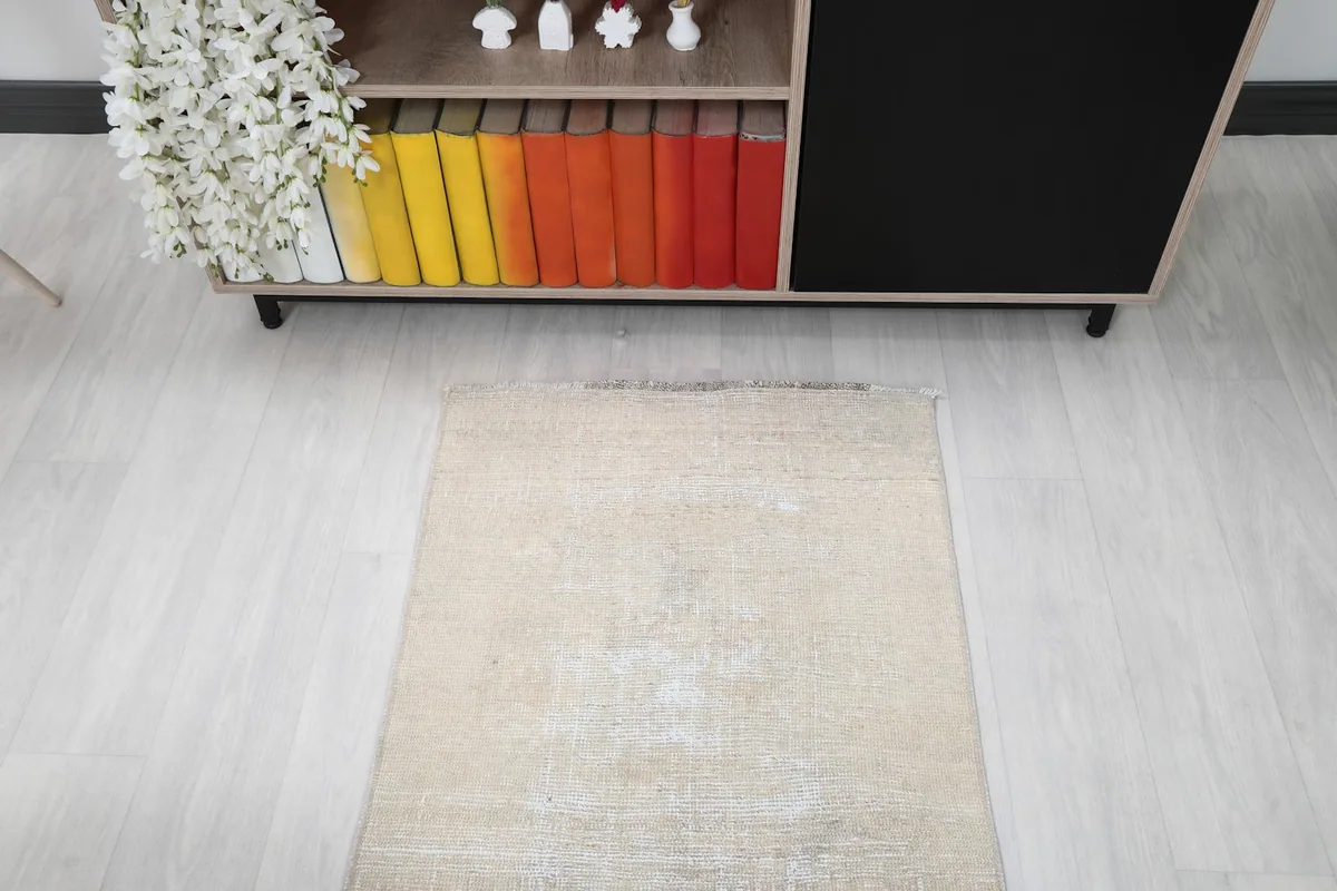Angled view of one end of the cream runner rug, showing its placement in a room
