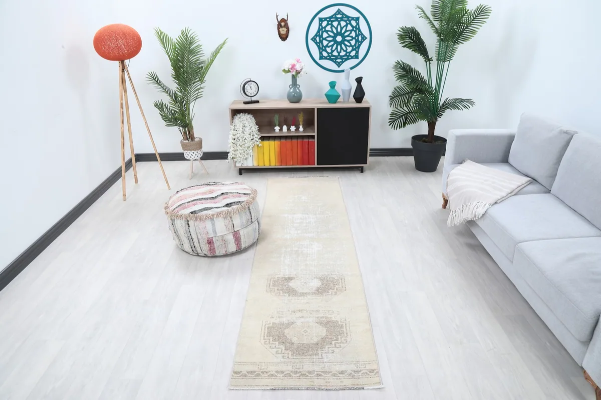 Cream and brown runner rug displayed in a modern living room setting with light flooring