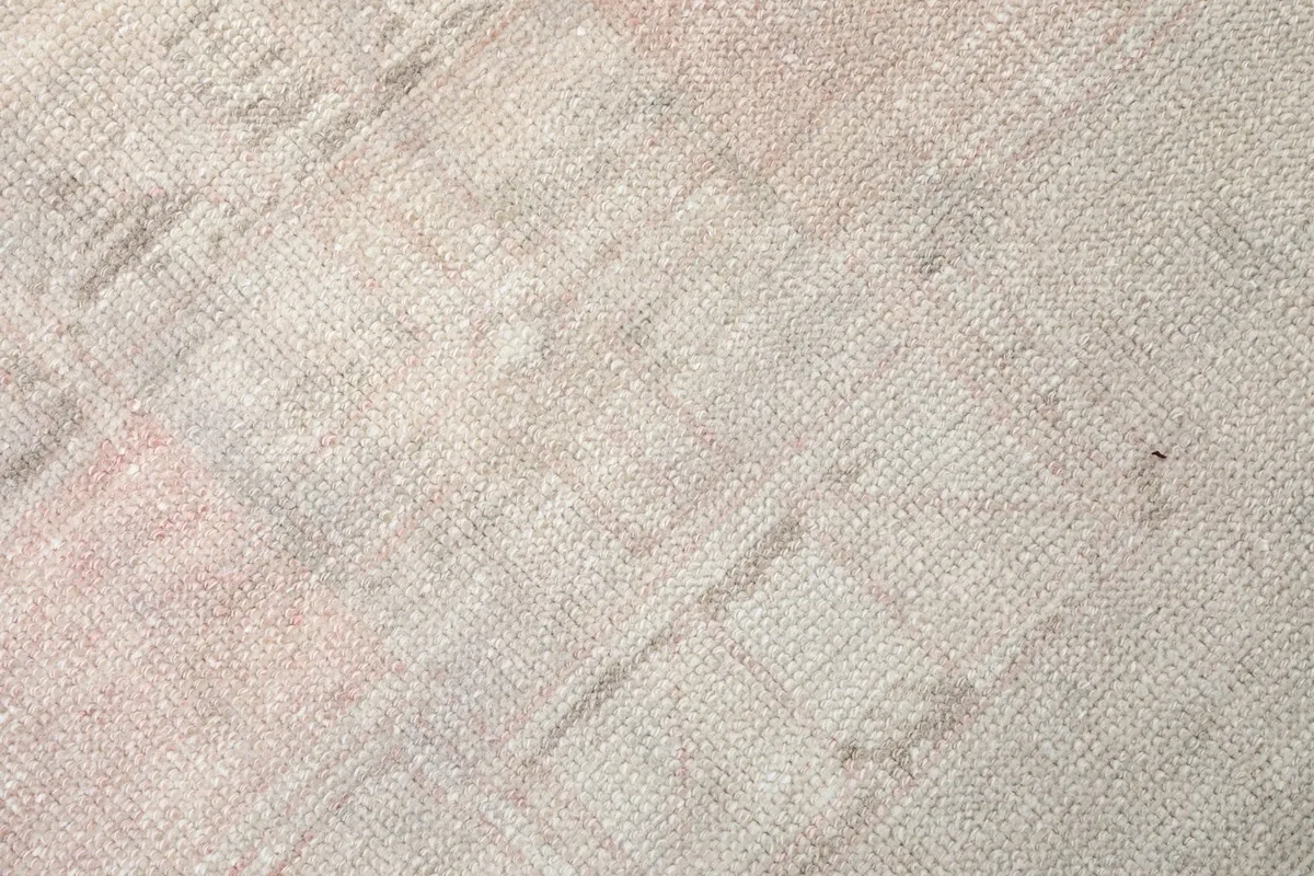 Texture detail of the hand-knotted wool pile, showing the low profile and weave