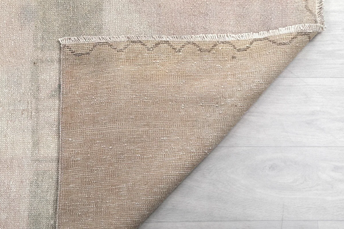 Another view of the rug's underside, showing the sturdy cotton foundation and craftsmanship