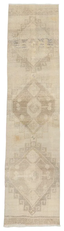 Full top view of the beige and gray geometric Anatolian runner on a white background.