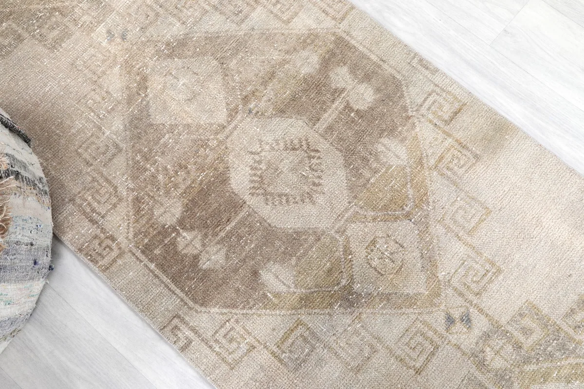 Close-up of a central geometric medallion on the runner, showing subtle color variations.
