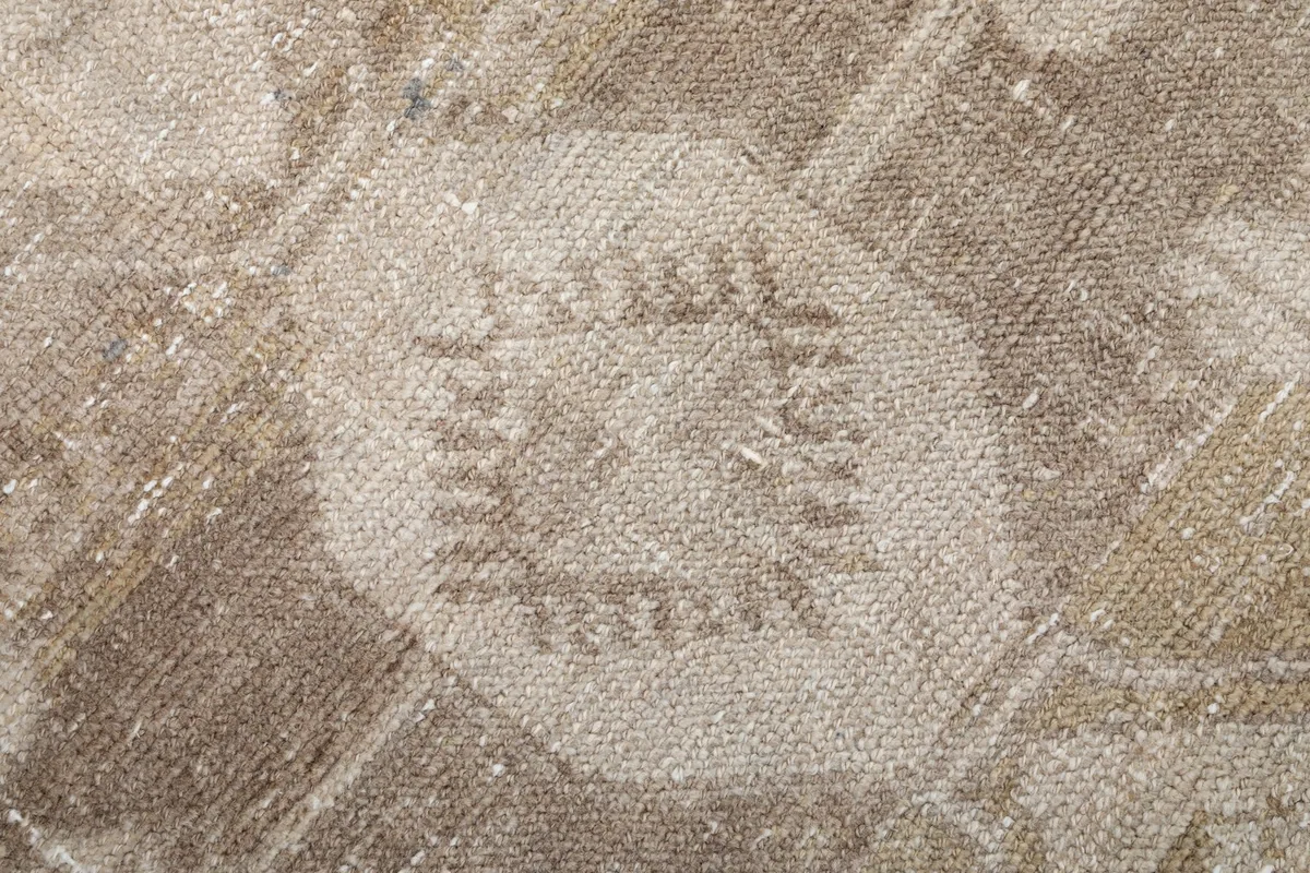Extreme close-up of the low wool pile and intricate knotting within a geometric design.