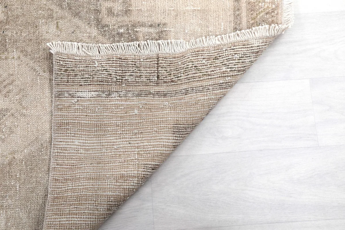 Close-up of the reverse side of the rug, revealing the tight knotting and wool fibers.