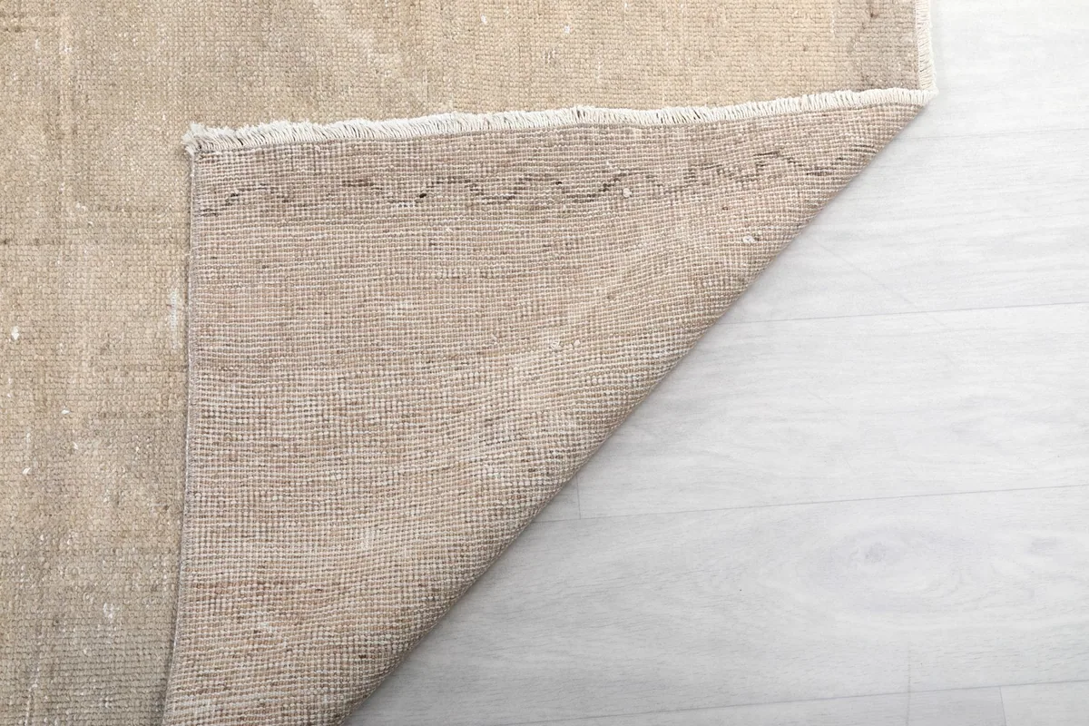 Another view of the back of the vintage runner rug, revealing the woven structure and craftsmanship