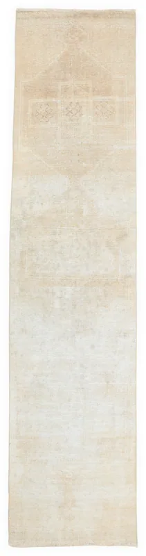 Full overhead view of the beige geometric Anatolian runner rug on a white background