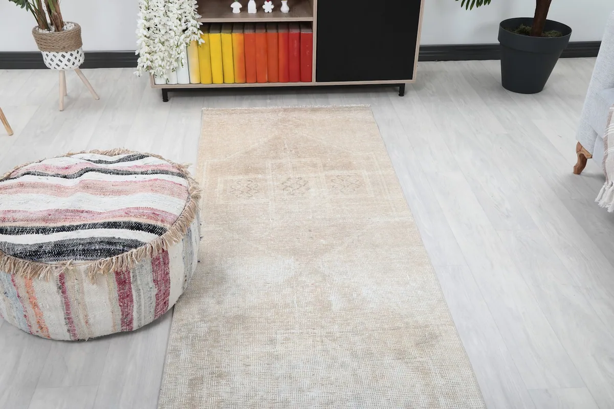Top-down view of the rug in a room, focusing on the geometric designs at one end