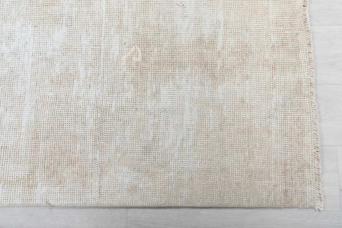 Detailed view of the rug's low pile and subtle texture, showing its vintage character