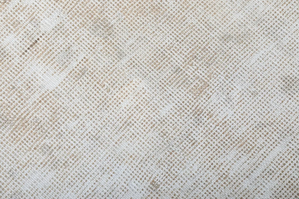 Close-up showing the tightly woven wool pile and cotton foundation visible through wear