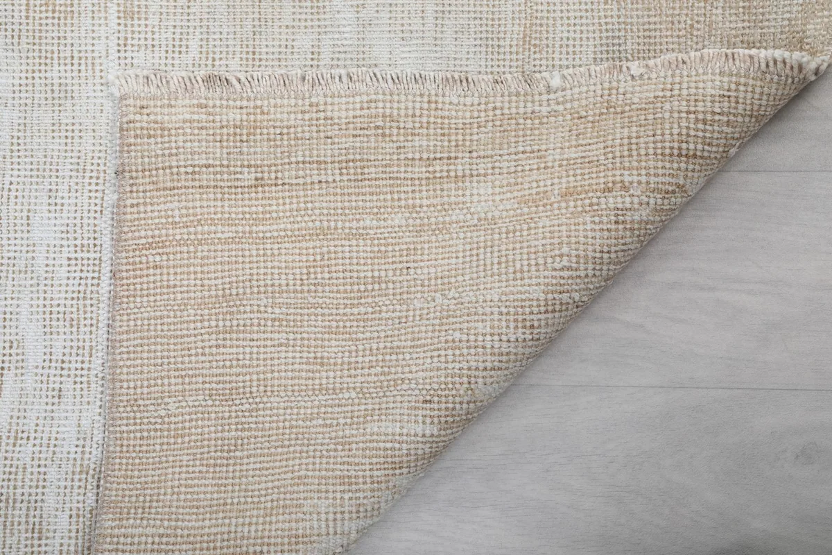 Folded corner of the rug showing the reverse side's texture and construction