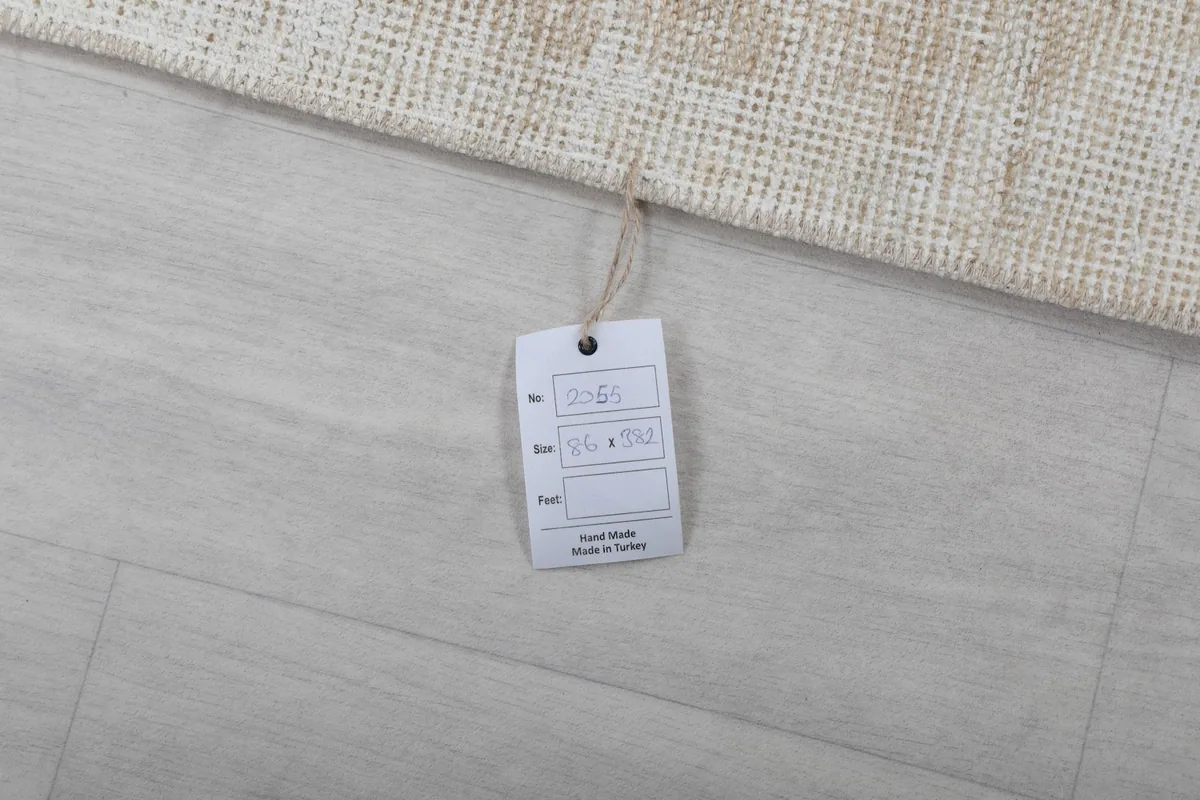 View of the product tag attached to the rug, displaying item number and dimensions