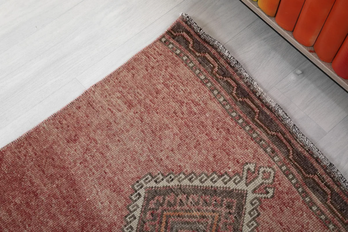 Close-up of the rug's edge, showing the subtle border design and texture