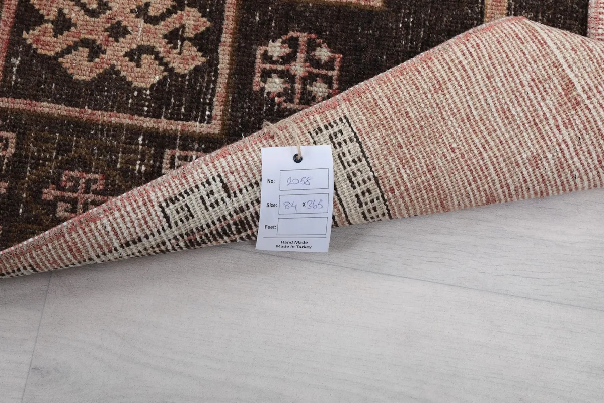 Close-up of the rug's back with a product tag displaying dimensions and details
