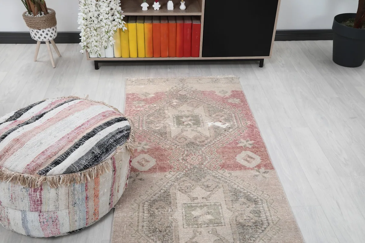 View of the runner rug from the end, showing the rose-colored section