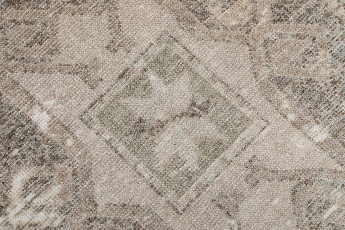 Intricate detail of an olive and beige star-like motif within a geometric pattern