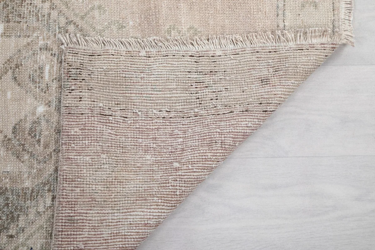 Close-up of the rug's back, revealing the tight weave of the cotton foundation